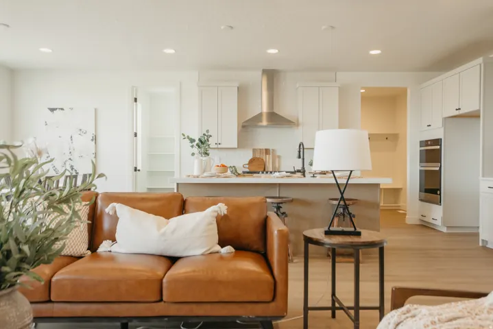 Open-concept living area with wood-finish flooring, recessed lighting, and a kitchen island