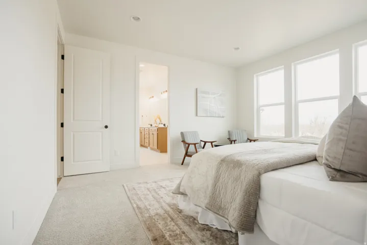 Recessed lighting, light-toned carpet flooring, and white walls