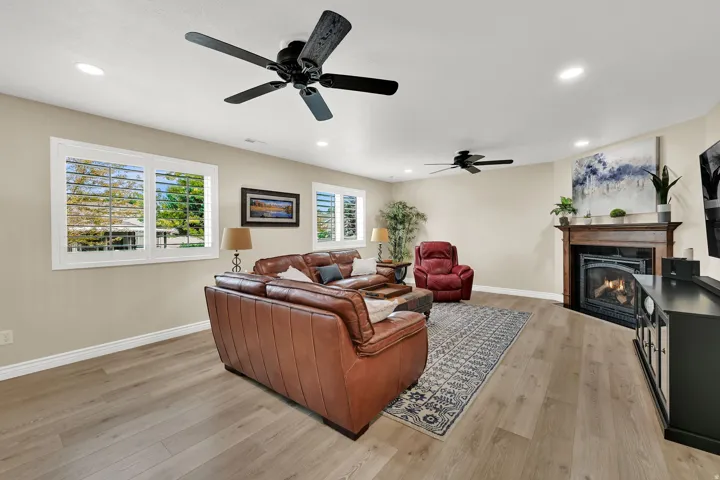 Wood-finish flooring, recessed lighting, and ceiling fans