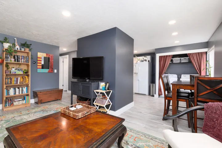 Recessed lighting throughout, wood-finish flooring, and built-in laundry area