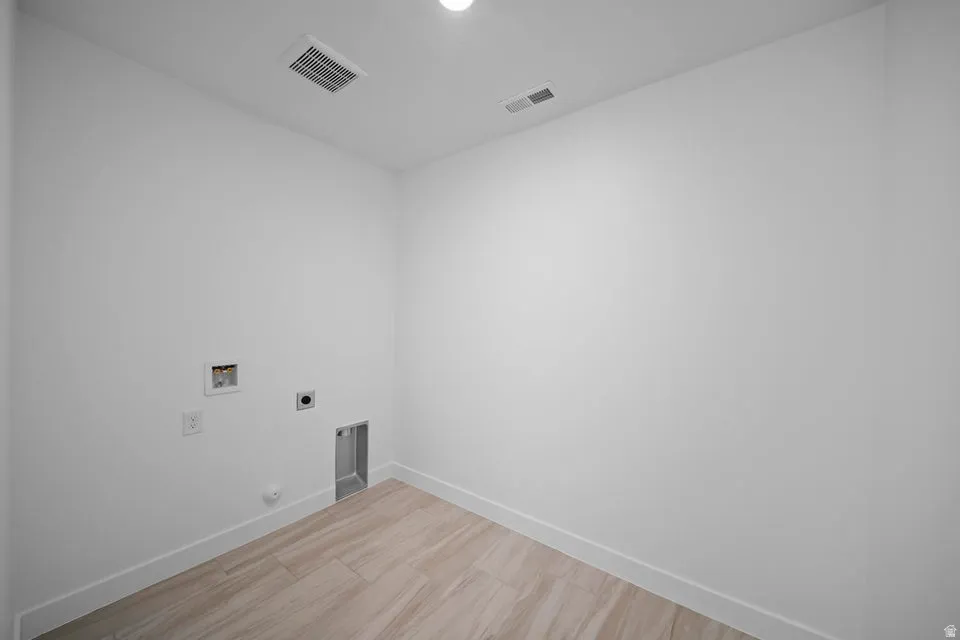 Utility connections with wood-finish flooring and recessed ceiling light