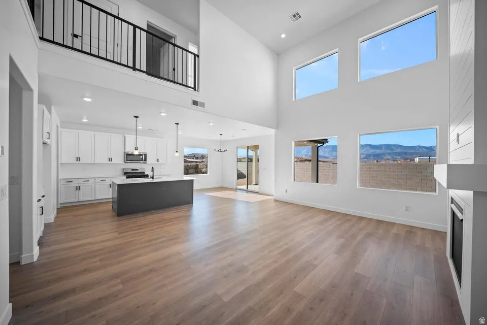 Open-concept living space with wood-finish flooring and high ceilings