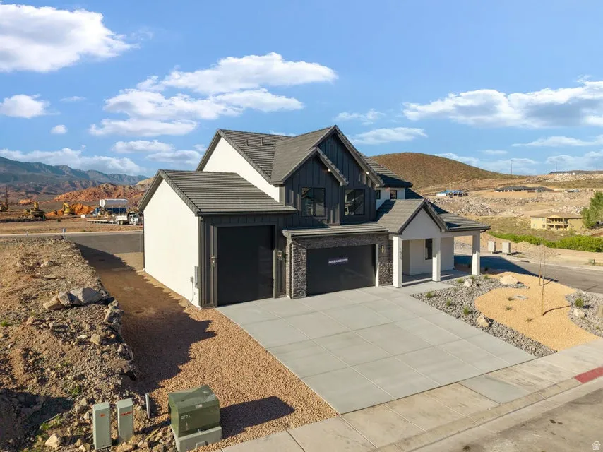 Modern exterior with dark vertical siding, light stucco, and stone accents
