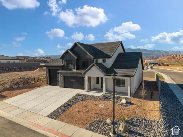 Contemporary exterior with a covered entry, two-car garage, and a low-maintenance landscape
