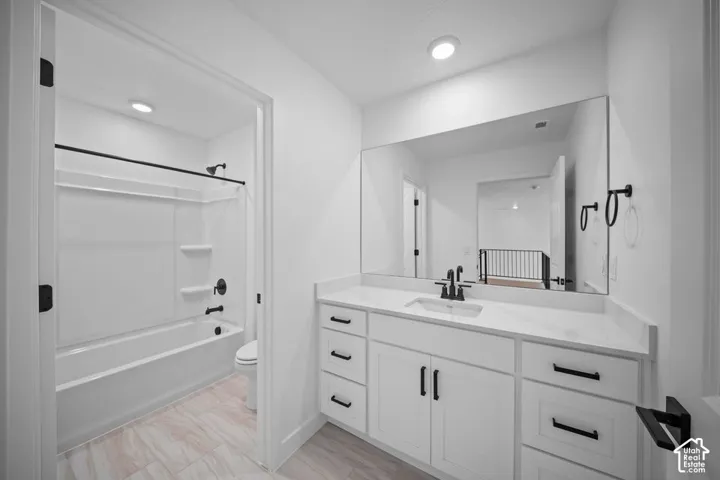 White vanity with ample storage, integrated sink, and black fixtures