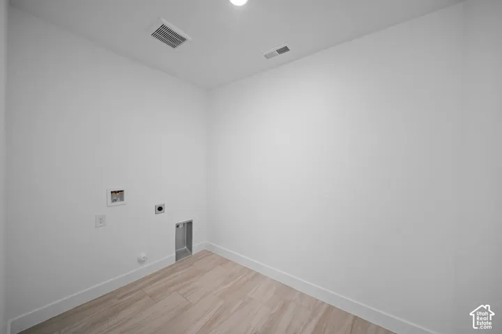 Utility connections with wood-finish flooring and recessed ceiling light