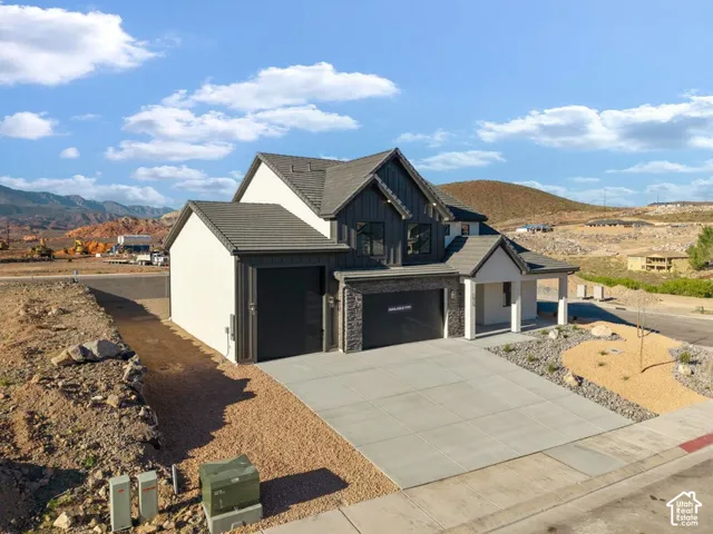 Modern exterior with dark vertical siding, light stucco, and stone accents