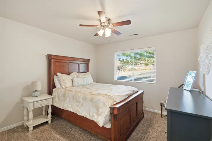 Recessed lighting, ceiling fan with light fixture, carpeted flooring, and a large window with blinds
