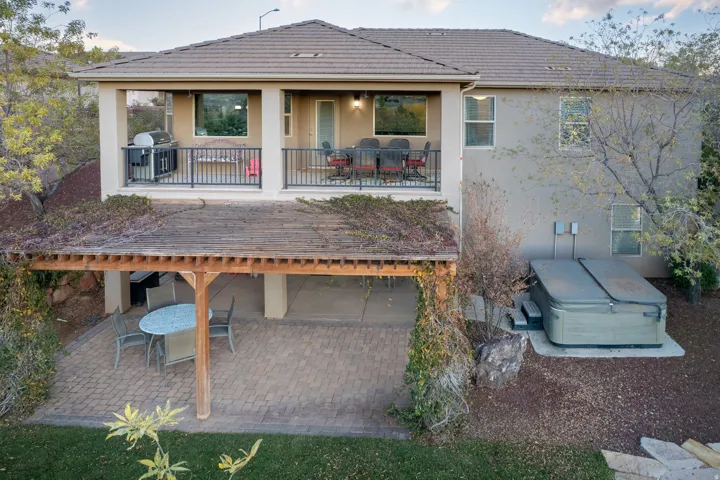 Covered patio featuring a wood pergola and paver stone hardscaping