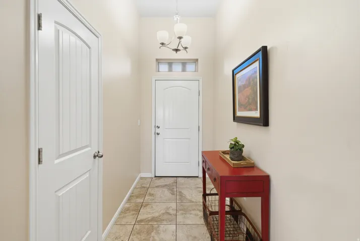 Tile flooring, transom window, and a ceiling-mounted light fixture