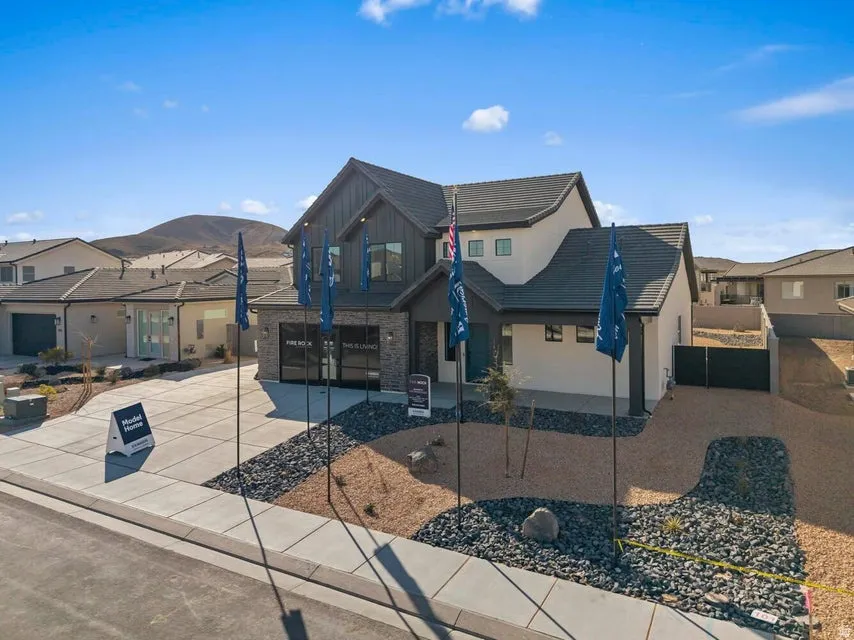 Contemporary exterior with a dark-tiled roof, stone accents, and an integrated garage