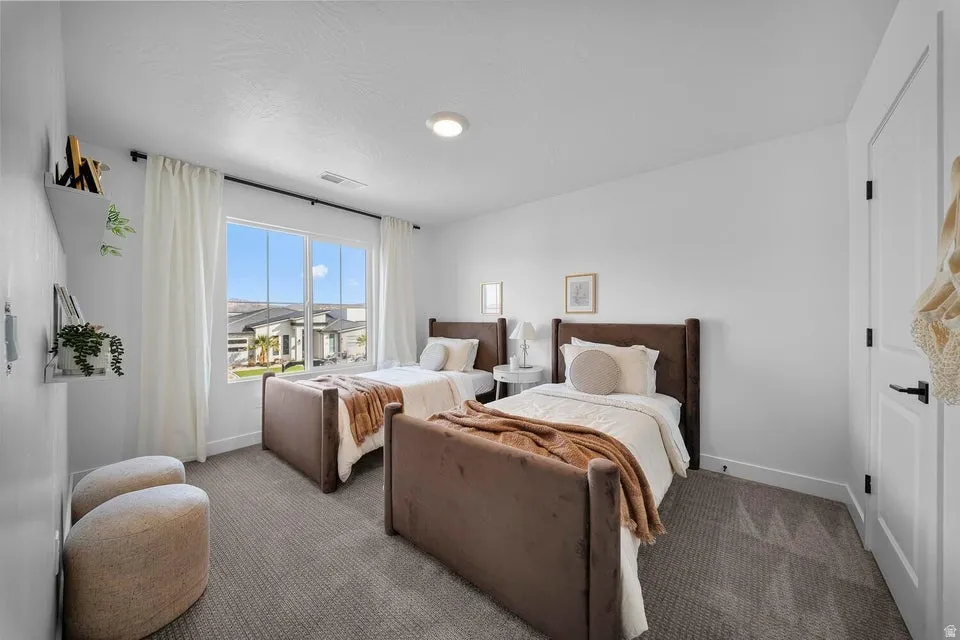 Recessed lighting, large window with white trim, white walls, and gray carpet
