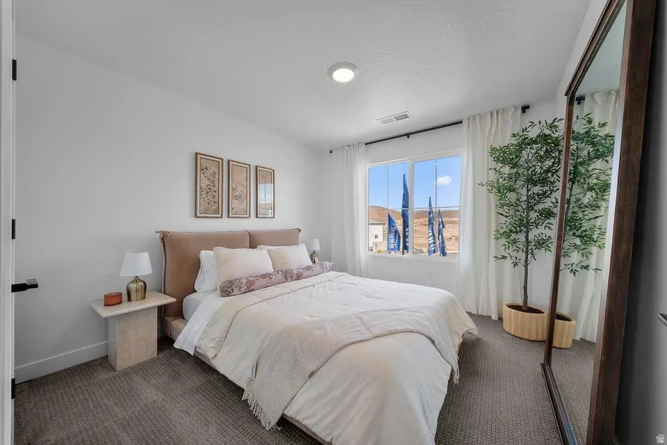 Carpeted room featuring a large window with white drapery, recessed lighting, and a dark-framed door