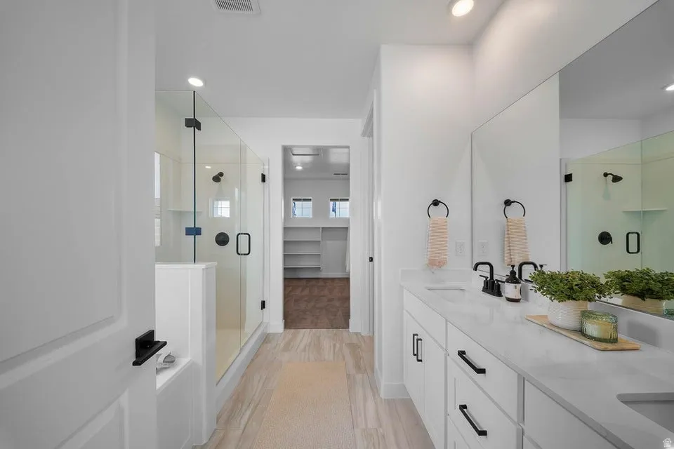Dual vanity with undermount sinks, stone countertops, and matte black fixtures