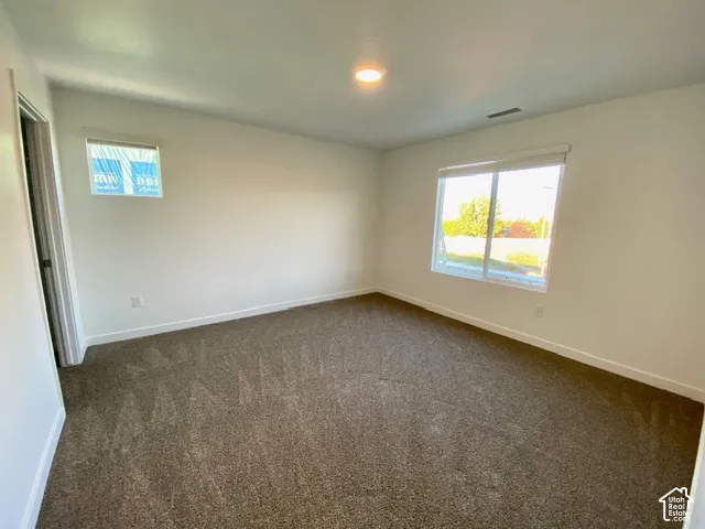Plush carpeting, recessed lighting, and bright white walls