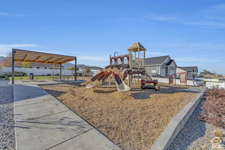 Neighborhood playground with play structure, slides, and wood chip surfacing