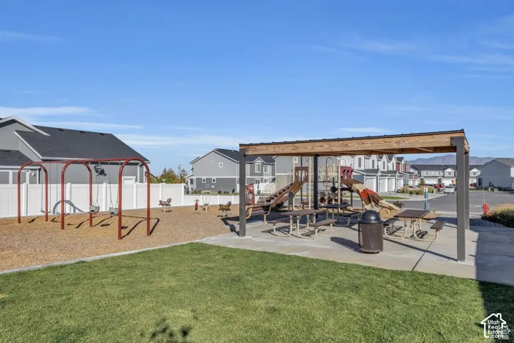 Community playground featuring swings, slides, and a covered picnic area