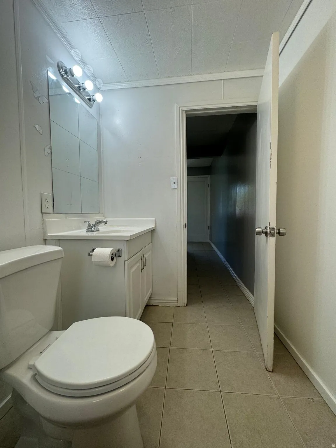 White vanity with dual cabinet doors and a single basin sink