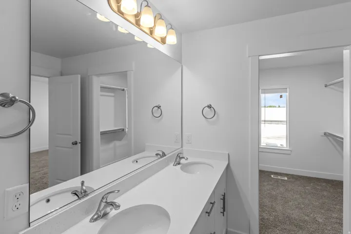 Dual vanity with undermount sinks, stone-finish countertop, and brushed nickel fixtures