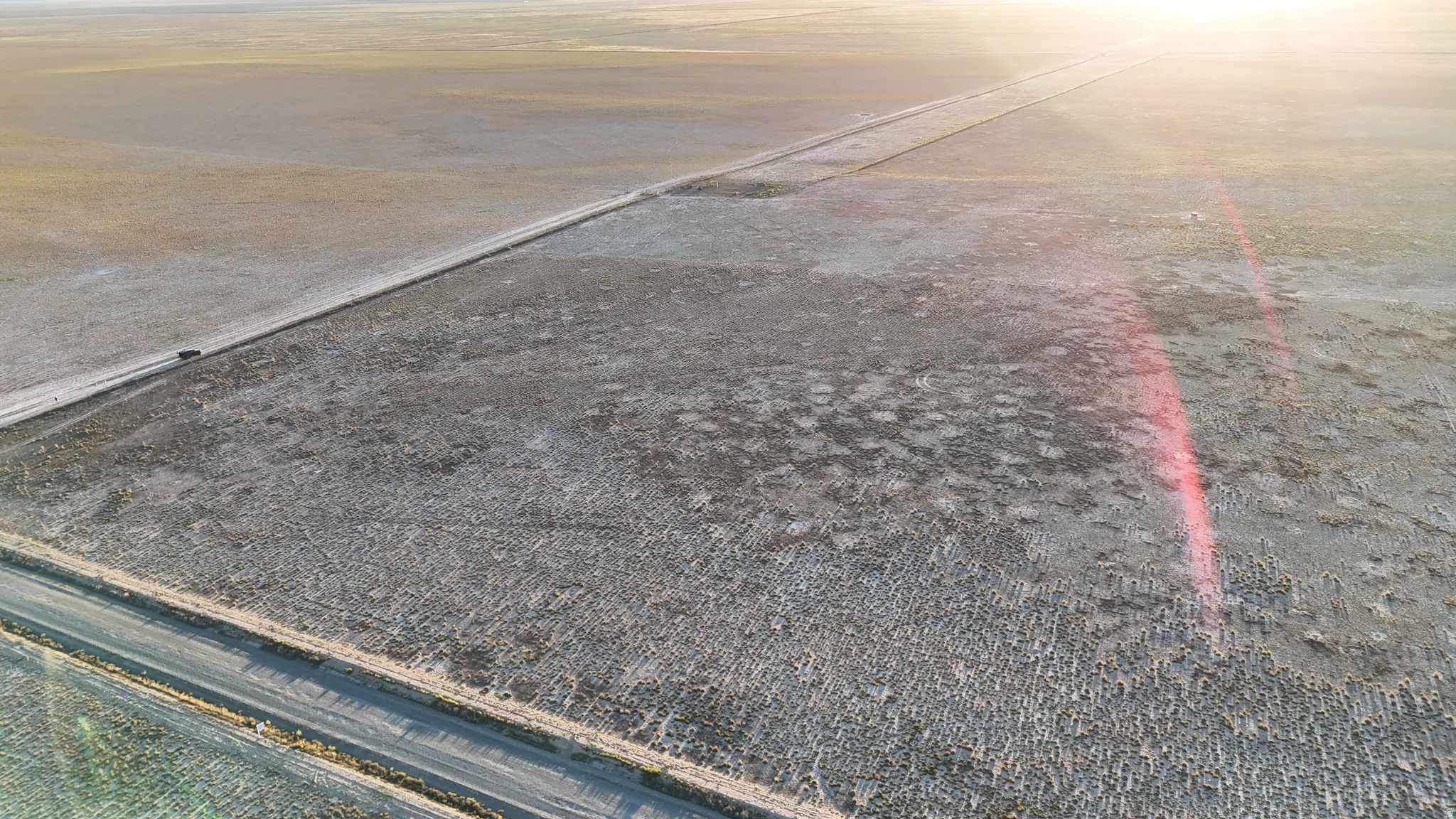 Expansive land parcel with visible road access
