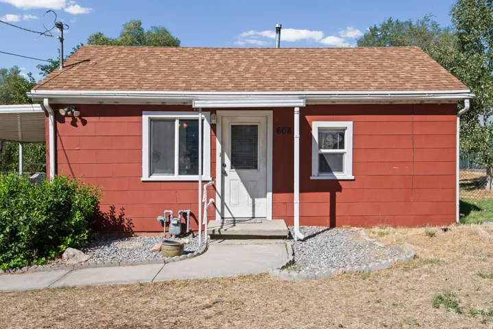 Red exterior siding with a light brown shingle roof
