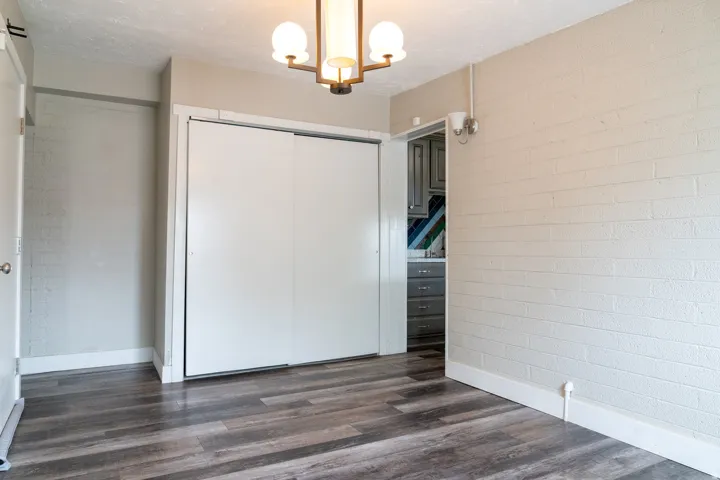 View toward the kitchen. Behind sliding glass doors are stacked washer-dryer.