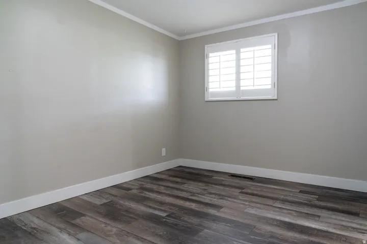 Primary bedroom with crown molding.