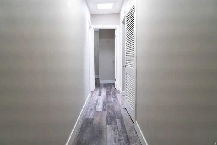 Hallway with skylight provides access to bedrooms.