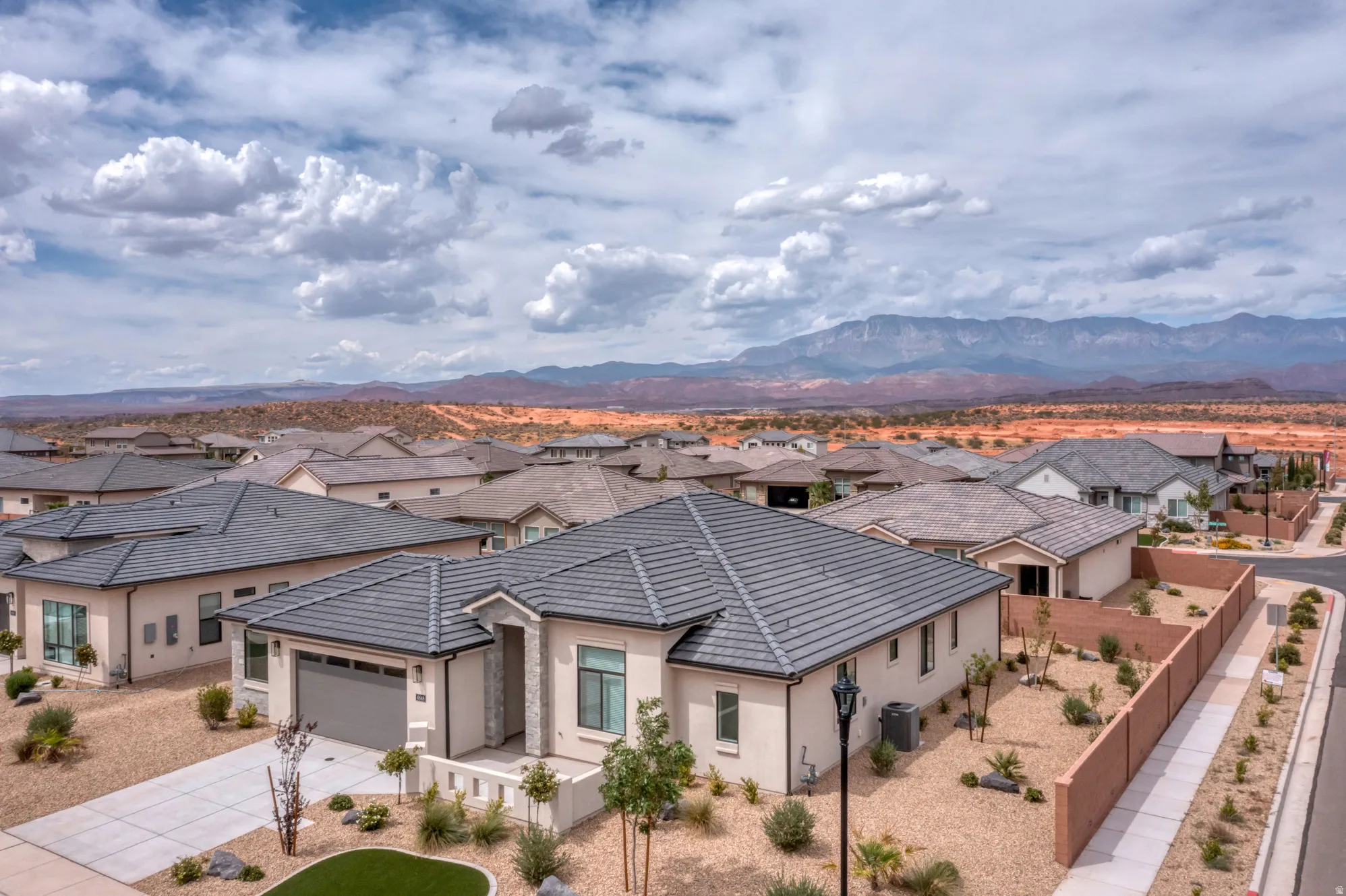 Single-story residence featuring a tile roof, stucco exterior, and a two-car garage