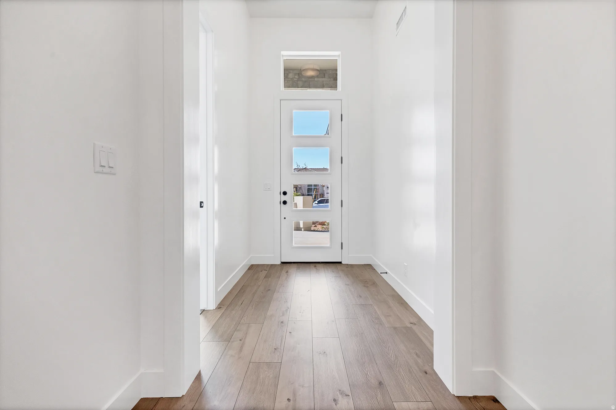 Entryway featuring a contemporary door with multiple lites and transom window