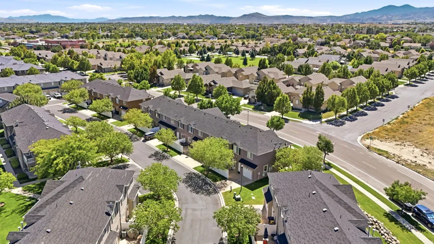 Residential neighborhood with structured streets, established landscaping, and mountain backdrop
