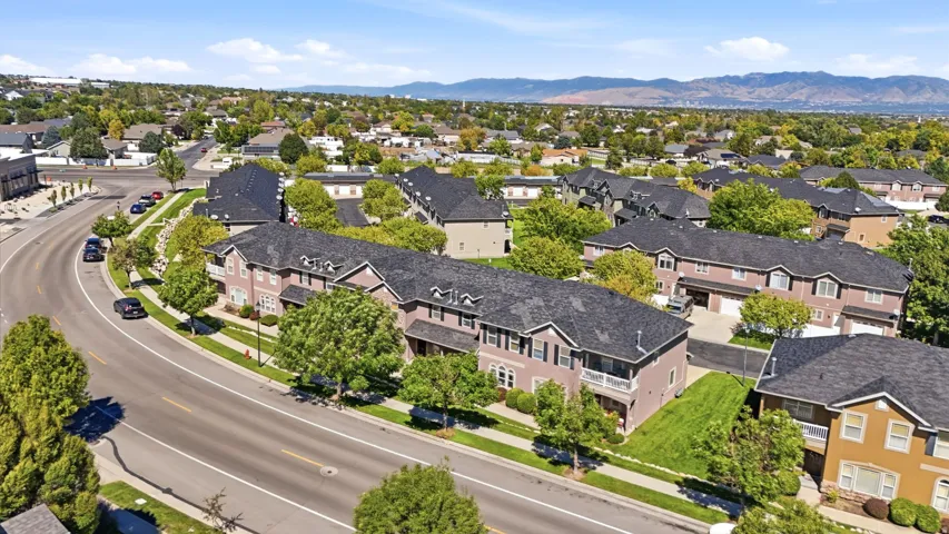 Residential community featuring multi-story structures with dark roofs