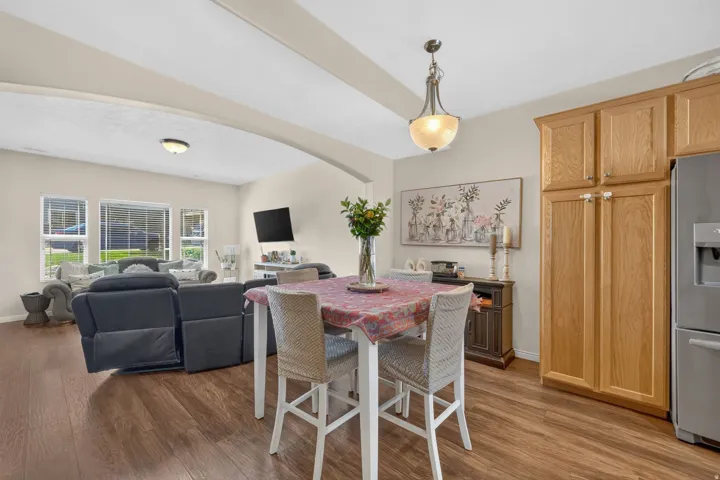 Wood-finish flooring throughout, light oak cabinetry, and arched ceiling details