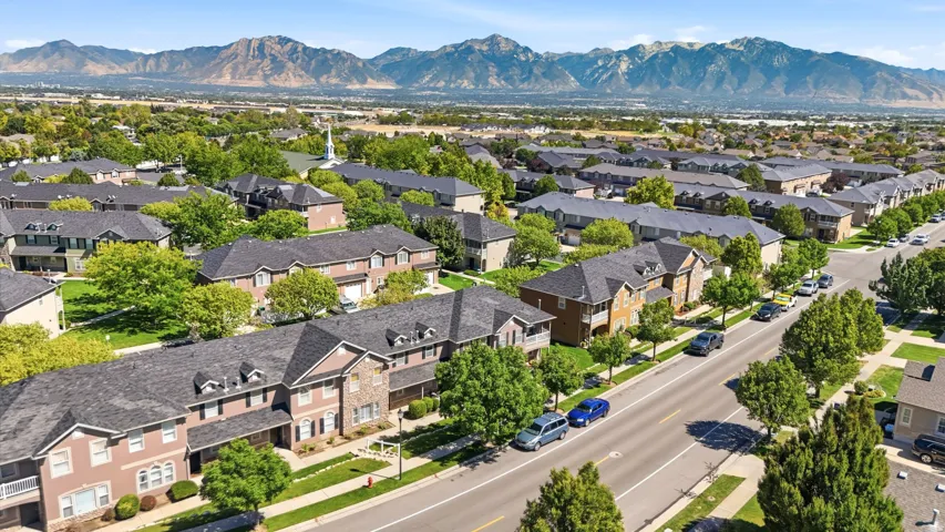 Neighborhood setting with mountain backdrop and mature trees