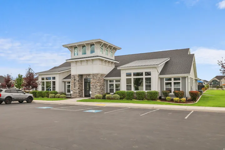 Contemporary exterior with stone facade accents, multiple large windows, and a prominent tower feature