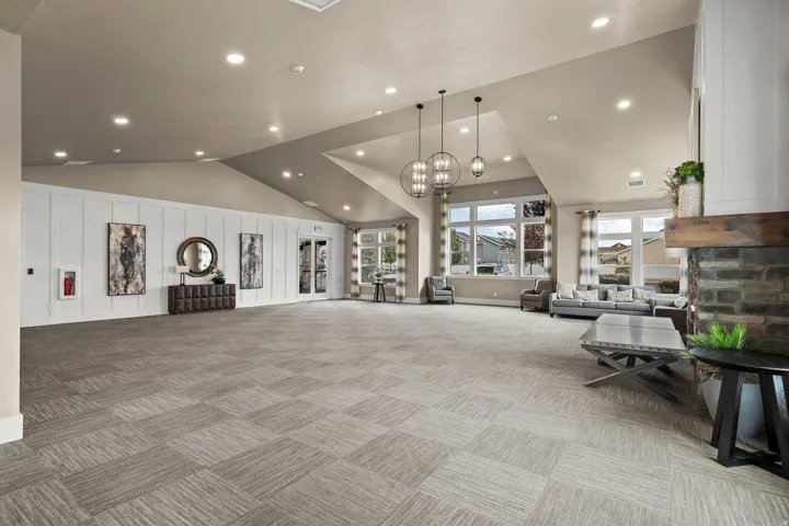 Spacious interior with vaulted ceilings, recessed lighting, and large windows