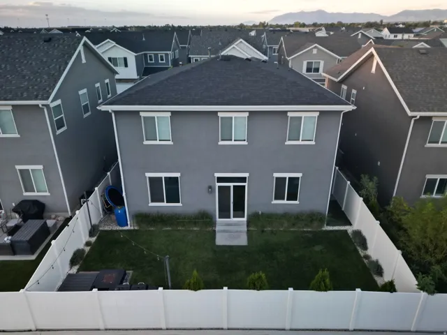 Two-story stucco exterior with multiple windows