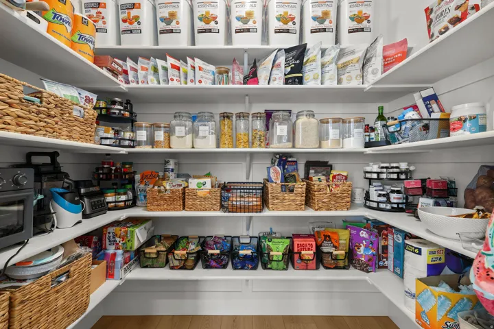 Custom pantry with ample shelving and wood-finish flooring