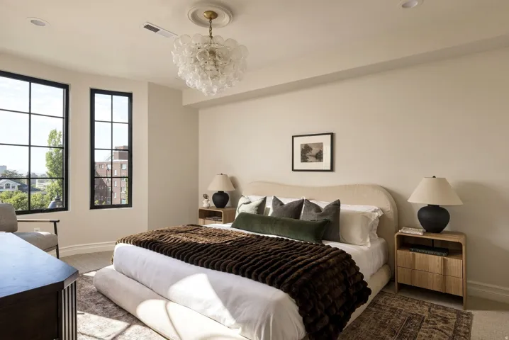 Recessed lighting, large grid-pattern windows, light wood-finish flooring, and an ornate ceiling fixture