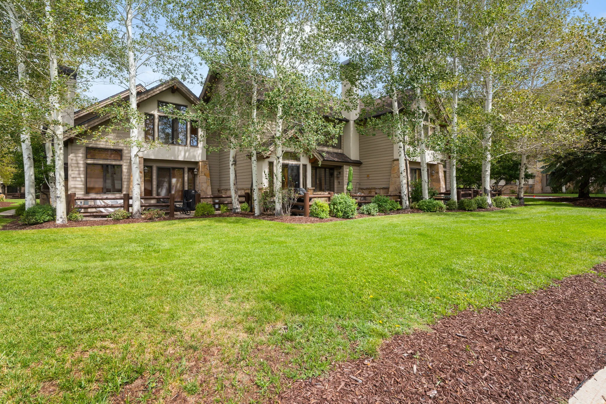 Expansive lawn bordered by wood chip landscaping