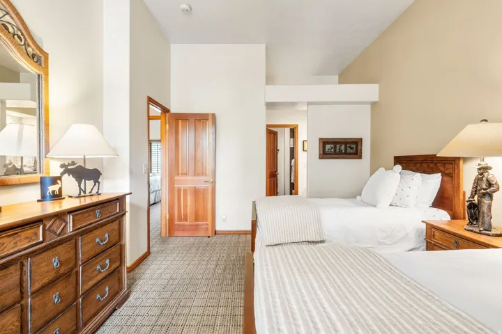 Vaulted ceilings, wood-finish doors, and patterned carpeting
