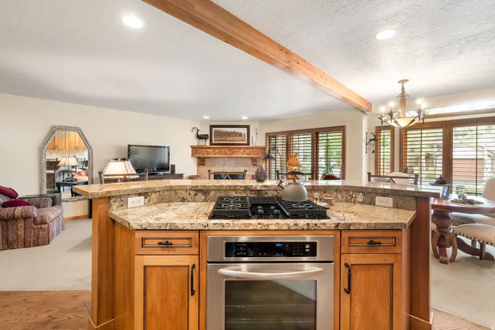 Kitchen island with integrated gas cooktop and stainless steel oven