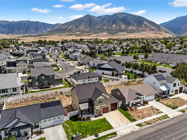 Mountain backdrop, residential neighborhood, cul-de-sac street, paved roads, and established housing