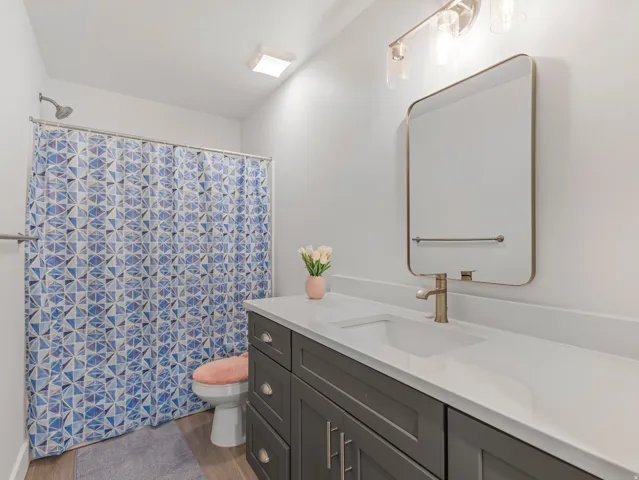 Modern vanity with dual-door cabinetry and drawer storage, integrated sink, and white countertop