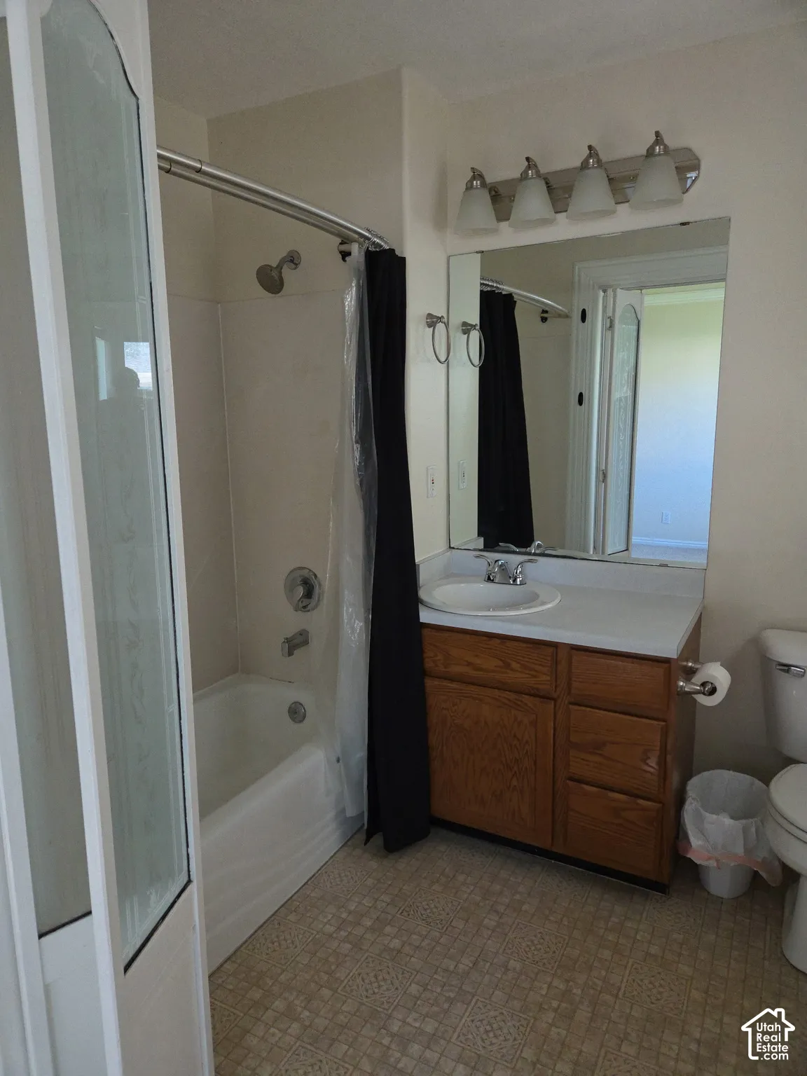 Bathroom with a single vanity, integrated sink, and wood-finish cabinetry