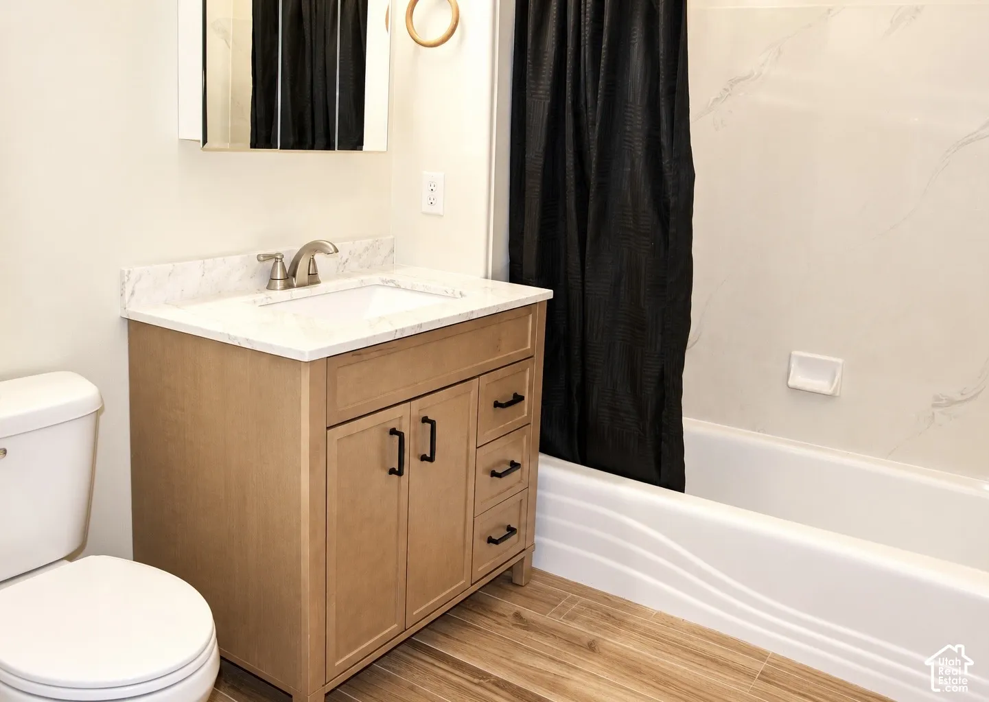 Updated main bathroomLight wood-finish vanity with a white countertop and rectangular undermount sink