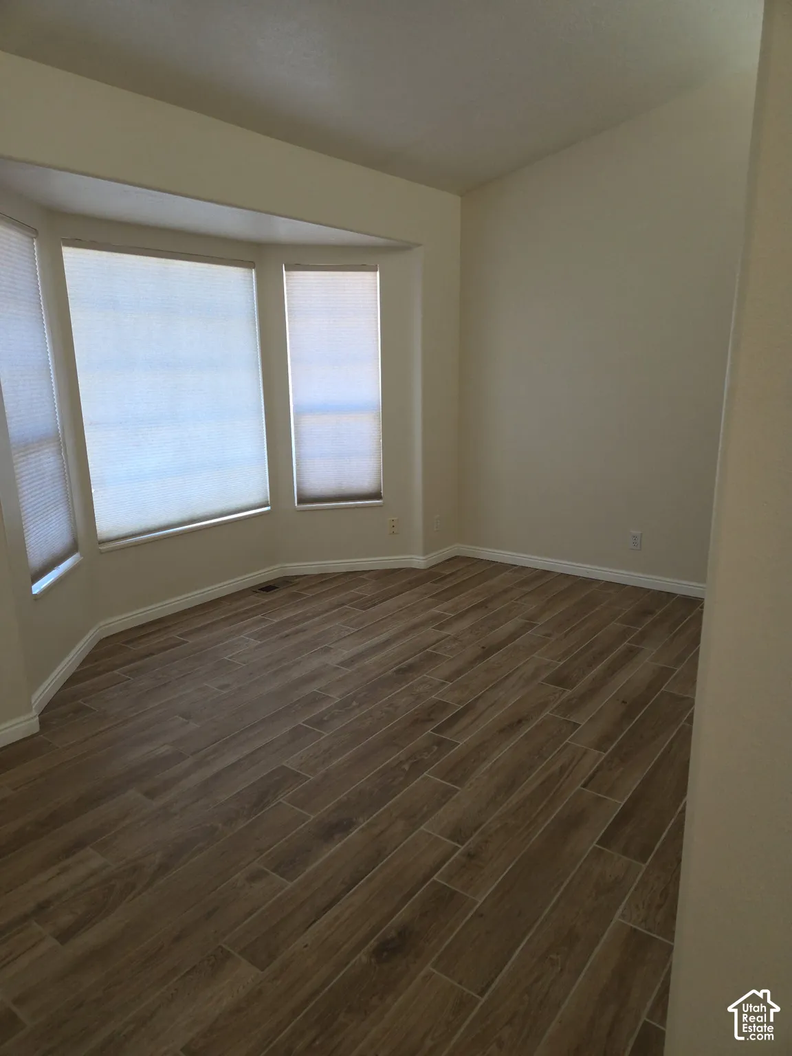 Bay window with three panels and roll-down shades