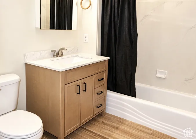Updated main bathroomLight wood-finish vanity with a white countertop and rectangular undermount sink