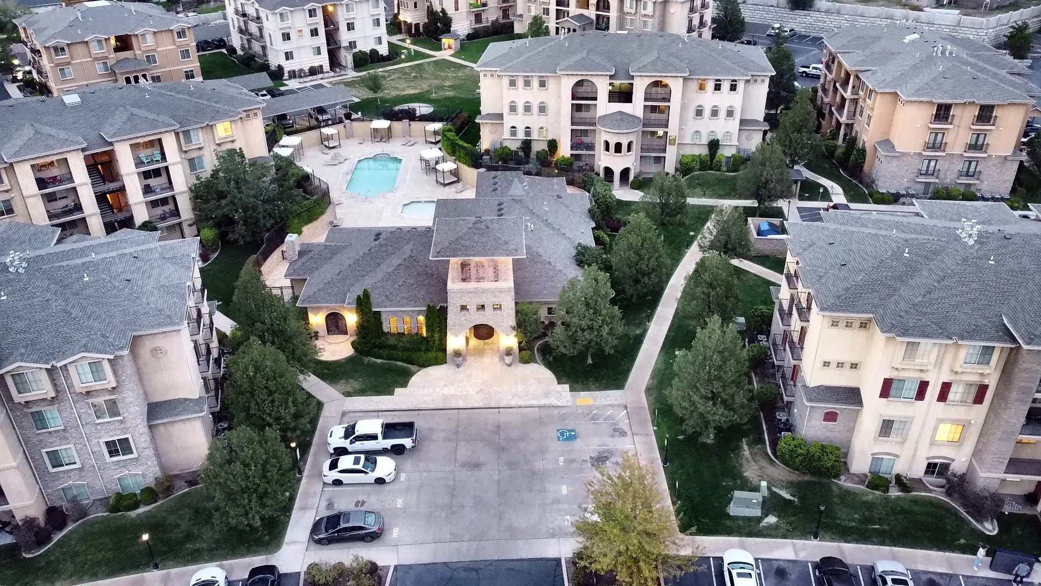 Clubhouse aerial views. Building exteriors featuring stone accents, balconies, and multiple windows