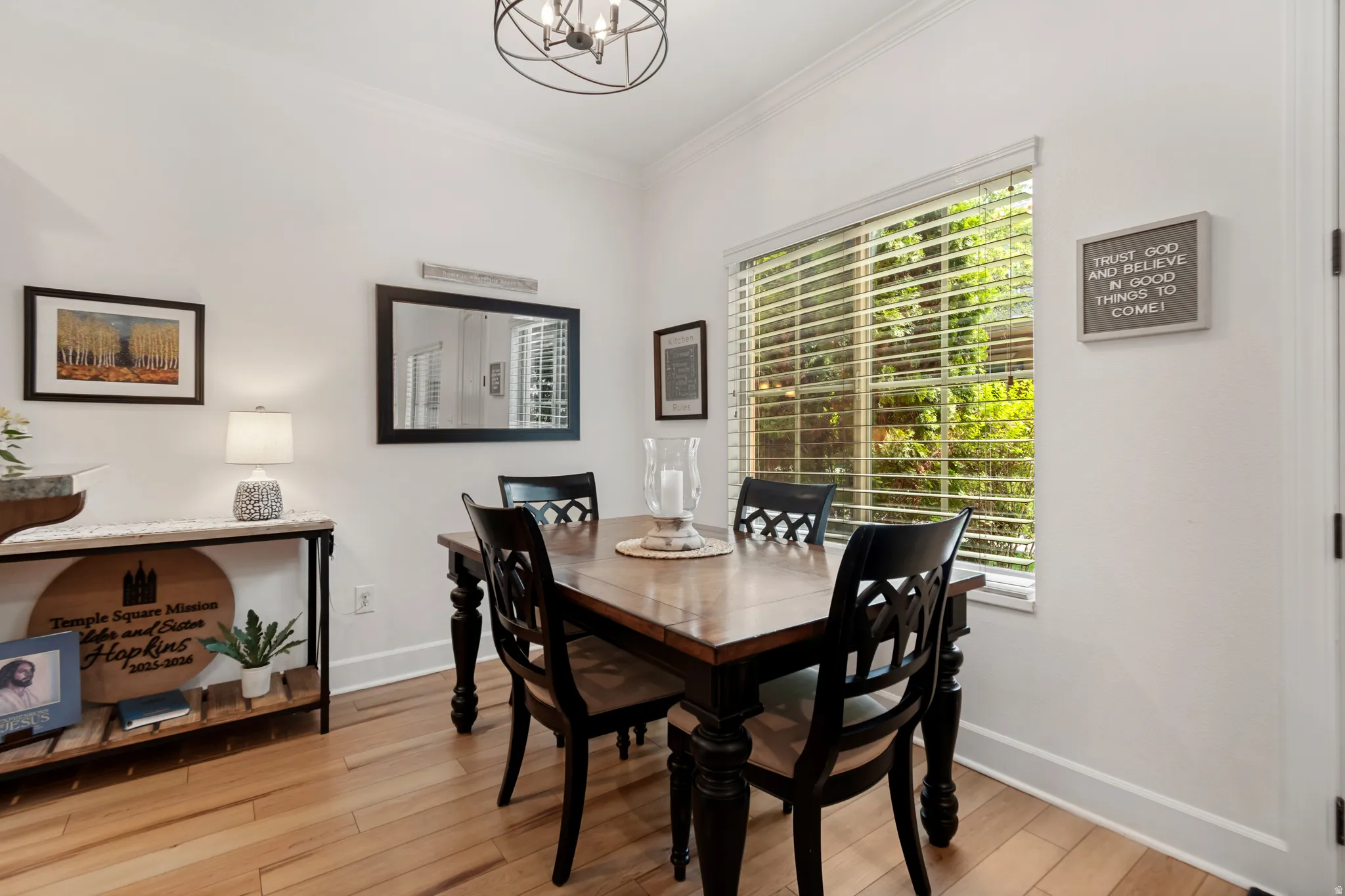 LVP flooring, crown molding, a window with blinds, and a built-in light fixture